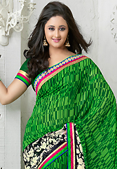 Get ready to sizzle all around you by sparkling saree. This green and black georgette saree is nicely designed with floral, abstract print, zari, lace and patch bordered work. Beautiful embroidery work on saree make attractive to impress all. This saree gives you a modern and different look in fabulous style. Matching blouse is available. Slight color variations are possible due to differing screen and photograph resolution.