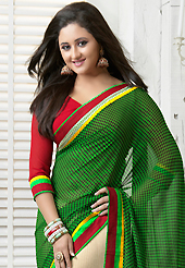 Elegance and innovation of designs crafted for you. This green and cream georgette saree is nicely designed with floral print and patch bordered work. Beautiful embroidery work on saree make attractive to impress all. This saree gives you a modern and different look in fabulous style. Contrasting red blouse is available. Slight color variations are possible due to differing screen and photograph resolution.