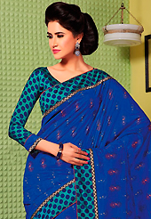 Style and trend will be at the peak of your beauty when you adorn this saree. This royal blue art silk saree is nicely designed with floral, polka dots print, self weaving zari and patch bordered work. Beautiful embroidery work on saree make attractive to impress all. This saree gives you a modern and different look in fabulous style. Contrasting turquoise green blouse is available. Slight color variations are possible due to differing screen and photograph resolution.