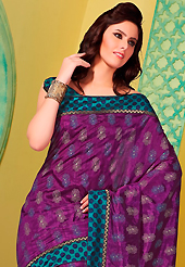 Welcome to the new era of Indian fashion wear. This dark magenta art silk saree is nicely designed with floral, polka dots print, self weaving zari and patch bordered work. Beautiful embroidery work on saree make attractive to impress all. This saree gives you a modern and different look in fabulous style. Contrasting turquoise green blouse is available. Slight color variations are possible due to differing screen and photograph resolution.