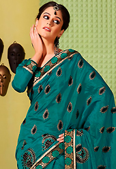 Embroidered sarees are the best choice for a girl to enhance her feminine look. This teal green art silk saree is nicely designed with foil print, self weaving zari and patch bordered work. Beautiful embroidery work on saree make attractive to impress all. This saree gives you a modern and different look in fabulous style. Matching blouse is available. Slight color variations are possible due to differing screen and photograph resolution.