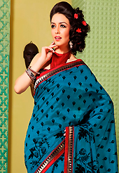 It is color this season and bright shaded suits are really something that is totally in vogue. This teal blue art silk saree is nicely designed with floral print, self weaving zari and patch bordered work. Beautiful embroidery work on saree make attractive to impress all. This saree gives you a modern and different look in fabulous style. Contrasting red blouse is available. Slight color variations are possible due to differing screen and photograph resolution.