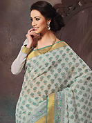 Ultimate collection of embroidered sarees with fabulous style. This beautiful off white and green cotton saree is nicely designed with floral, abstract print and self weaving zari work. Beautiful print work on saree make attractive to impress all. It will enhance your personality and gives you a singular look. Matching blouse is available with this saree. Slight color variations are due to differing screen and photography resolution.