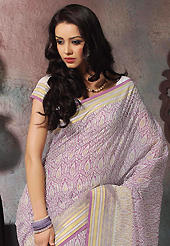 Keep the interest with this printed saree. This beautiful off white and lavender cotton saree is nicely designed with abstract print and self weaving zari work. Beautiful print work on saree make attractive to impress all. It will enhance your personality and gives you a singular look. Matching blouse is available with this saree. Slight color variations are due to differing screen and photography resolution.