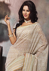 Make a trendy look with this classic printed saree. This beautiful off white and light brown cotton saree is nicely designed with abstract print and self weaving zari work. Beautiful print work on saree make attractive to impress all. It will enhance your personality and gives you a singular look. Matching blouse is available with this saree. Slight color variations are due to differing screen and photography resolution.