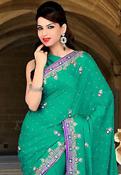 Attract all attentions with this embroidered saree. This green faux chiffon saree have beautiful embroidery patch work which is embellished with sequins, stone and cutbeads work. Fabulous designed embroidery gives you an ethnic look and increasing your beauty. Matching blouse is available. Slight Color variations are possible due to differing screen and photograph resolutions.