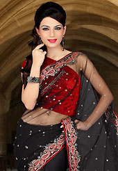 Style and trend will be at the peak of your beauty when you adorn this saree. This black net saree have beautiful embroidery patch work which is embellished with stone and cutbeads work. Fabulous designed embroidery gives you an ethnic look and increasing your beauty. Contrasting red velvet blouse is available. Slight Color variations are possible due to differing screen and photograph resolutions.