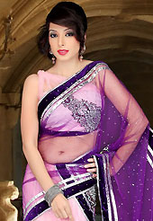 Take the fashion industry by storm in this beautiful embroidered saree. This pink and dark purple net lehenga style saree have beautiful embroidery and velvet patch work which is embellished with zari, stone, cutdana and cutbeads work. Fabulous designed embroidery gives you an ethnic look and increasing your beauty. Matching blouse is available. Slight Color variations are possible due to differing screen and photograph resolutions.