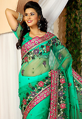 Elegance and innovation of designs crafted for you. This green net saree is nicely designed with embroidered patch work is done with resham, zari and stone work. Beautiful embroidery work on saree make attractive to impress all. This saree gives you a modern and different look in fabulous style. Matching blouse is available. Slight color variations are possible due to differing screen and photograph resolution.