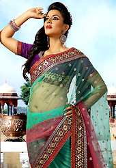 Take the fashion industry by storm in this beautiful embroidered saree. This shaded green and maroon net saree is nicely designed with embroidered patch work is done with resham, zari, sequins and beaded lace work. Beautiful embroidery work on saree make attractive to impress all. This saree gives you a modern and different look in fabulous style. Contrasting dark purple blouse is available. Slight color variations are possible due to differing screen and photograph resolution.