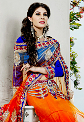 Look stunning rich with dark shades and floral patterns. This dark orange net saree have beautiful embroidery patch work which is embellished with resham, zari, stone, cutdana, beads and lace work. Fabulous designed embroidery gives you an ethnic look and increasing your beauty. Contrasting royal blue blouse is available. Slight Color variations are possible due to differing screen and photograph resolutions.