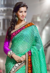 Style and trend will be at the peak of your beauty when you adorn this saree. This sea green jacquard silk saree have beautiful embroidery patch work which is embellished with resham work. Fabulous designed embroidery gives you an ethnic look and increasing your beauty. Contrasting magenta blouse is available. Slight Color variations are possible due to differing screen and photograph resolutions.