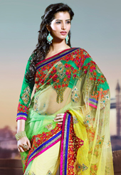 Take a look on the changing fashion of the season. This yellow and green net saree have beautiful embroidery patch work which is embellished with resham, zari and stone work. Fabulous designed embroidery gives you an ethnic look and increasing your beauty. Contrasting green blouse is available. Slight Color variations are possible due to differing screen and photograph resolutions.