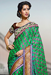 Style and trend will be at the peak of your beauty when you adorn this saree. This shaded green viscose georgette saree have beautiful embroidery patch work which is embellished with resham, zari and stone work. Fabulous designed embroidery gives you an ethnic look and increasing your beauty. Contrasting dark red blouse is available. Slight Color variations are possible due to differing screen and photograph resolutions.