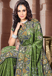 The traditional patterns used on this saree maintain the ethnic look. This olive green color saree make you trendy look. This Drape has a beautiful handwork of sitara, dhaga, stone work. Floral butti and border make different to others. Color blend of this saree is nice. Matching designer is blouse. This saree also available in Purple, Navy Blue, Maroon colors. Slight color variations are possible due to differing screen and photograph resolution.