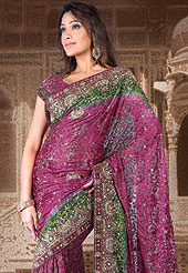 Let your personality speak for you this Dark pink color saree embellished with embroidery work.  The stylish and amazing floral pattern made it attractive and unique to others. Border of saree is beautified with Sequins, stone, zari, resham work. The saree is specially crafted for your stunning look and terrific style with this matching blouse. This saree also available in Red, Blue colors. Slight Color variations are possible due to differing screen and photograph resolutions.