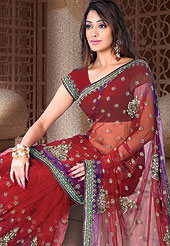 Designer Saree in material with georgette maintain the artistic look as well as present look. This red Lehenga style saree have floral grave embroidery and ceroski on all over saree. Pallu is embellished with sequins, resham, stone and zari work patch. This saree gives you an ethnic look and increasing your beauty. Matching Blouse is available. This saree is also available in Green, Magenta, Purple colors. Slight Color variations are possible due to differing screen and photograph resolutions.