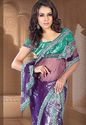 The traditional patterns used on this saree maintain the ethnic look. This Purple-green Lehenga style saree make you trendy look. This Drape has a beautiful handwork of sitara, dhaga, stone work. Floral embroidery on bottom and border make different to others. Color blend of this saree is nice. Matching designer is blouse. This saree is also available in Red and Blue colors. Slight color variations are possible due to differing screen and photograph resolution.  