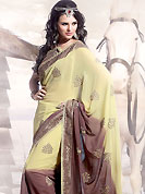 Welcome to the new era of Indian fashion wear. This yellow and violet faux georgette saree is beautifully encrafted with resham, zari and patch work in floral patterns. As shown blouse can be made possible and also can be customized as per your style subject to fabric limitation.  Slight color variations are possible due to differing screen and photograph resolution.
