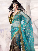 Emblem of fashion and beauty, each piece of our range of designer saree is certain to enhance your look as per today’s trends. This aqua blue and deep brown tissue and faux shimmer georgette saree is beautifully adorned with zari and patch work in floral patterns. Matching blouse is available with this, blouse shown in the image is just for photography purpose.  Slight color variations are possible due to differing screen and photograph resolution.