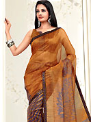 It is color this season and bright shaded suits are really something that is totally in vogue. This orange and violet net printed casual wear saree have floral print patch on pallu and lines print on all over the saree. Border has amazing contrasting fabric lace. It’s cool and has a very modern look to impress all. Matching blouse is available.  Slight Color variations are possible due to differing screen and photograph resolutions.