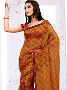 Breathtaking collection of sarees with stylish print work and fabulous style. This orange net printed casual wear saree have floral butti print on all over the saree. Border has amazing contrasting fabric lace. It’s cool and has a very modern look to impress all. Matching blouse is available.  Slight Color variations are possible due to differing screen and photograph resolutions.