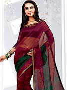 The very silhouette and styling of this outfit proves quiet flattering for most body types and renders a rather grand and majestic appeal. This red and green net printed casual wear saree have floral and strip print on all over. Border has amazing contrasting fabric lace. It’s cool and has a very modern look to impress all. Matching blouse is available.  Slight Color variations are possible due to differing screen and photograph resolutions.