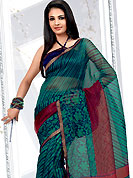 The very silhouette and styling of this outfit proves quiet flattering for most body types and renders a rather grand and majestic appeal. This turquoise blue and red net printed casual wear saree have floral and strip print on all over. Border has amazing contrasting fabric lace. It’s cool and has a very modern look to impress all. Matching blouse is available.  Slight Color variations are possible due to differing screen and photograph resolutions.