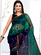 Let your personality articulate for you with this amazing printed saree. This dark blue and turquoise green net printed casual wear saree have beautiful abstract and geometrical art print work on all over. Border has amazing contrasting fabric lace. It’s cool and has a very modern look to impress all. Matching blouse is available.  Slight Color variations are possible due to differing screen and photograph resolutions.