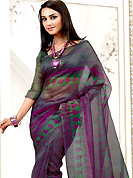 The most radiant carnival of style and beauty. This purple net printed casual wear saree have beautiful zigzag and butti print work on all over. Border has amazing contrasting fabric lace. It’s cool and has a very modern look to impress all. Matching blouse is available.  Slight Color variations are possible due to differing screen and photograph resolutions.