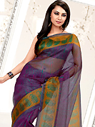 An endearing splash oh colors look gorgeous tridimensional charm. This violet net printed casual wear saree have beautiful abstract lines and butti print work on all over. Border has amazing contrasting fabric lace. It’s cool and has a very modern look to impress all. Matching blouse is available.  Slight Color variations are possible due to differing screen and photograph resolutions.