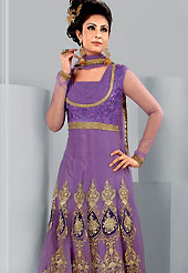 Era with extension in fashion, style, Grace and elegance have developed grand love affair with this ethnical wear. This Gorgeous violet suit has long kameez which is designed with beautiful zari embroidered velvet patch work in floral patterns. This drape material is net. Matching churidar and embroidered dupatta is available. Slight color variations are possible due to differing screen and photograph resolutions.